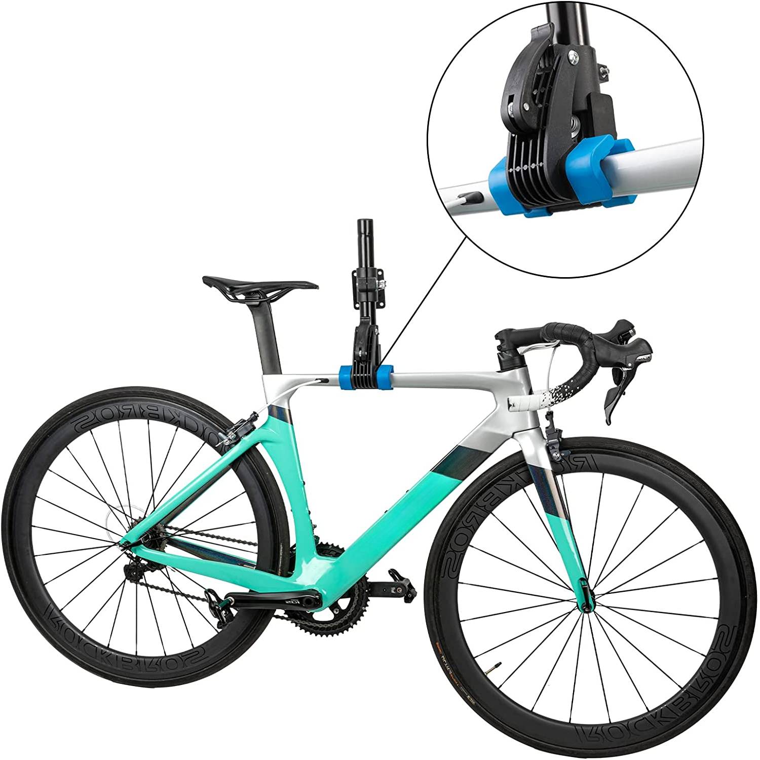 Road bike held by its top tube in the repair clamp