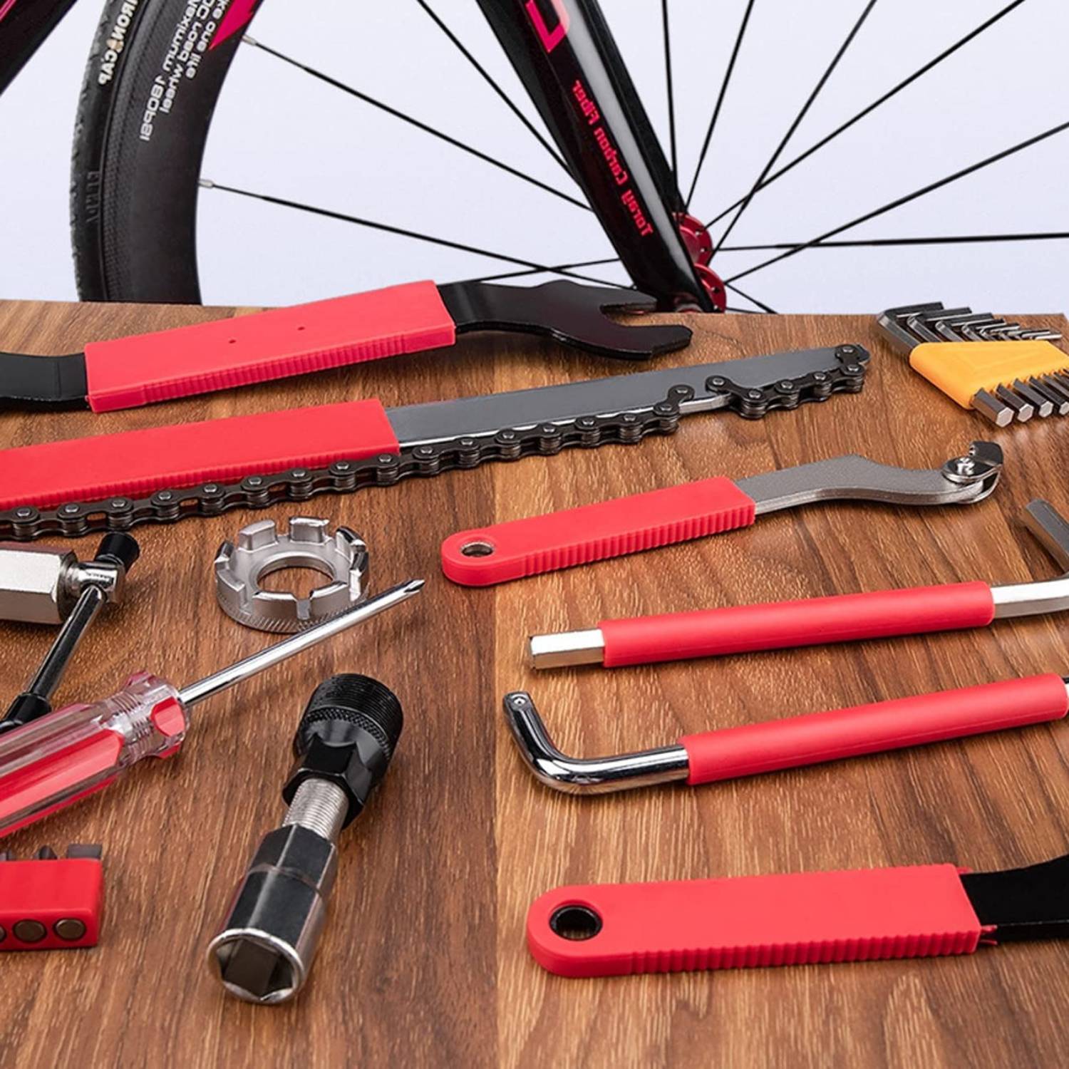 Bike repair tools laid out on a wooden bench next to a bicycle