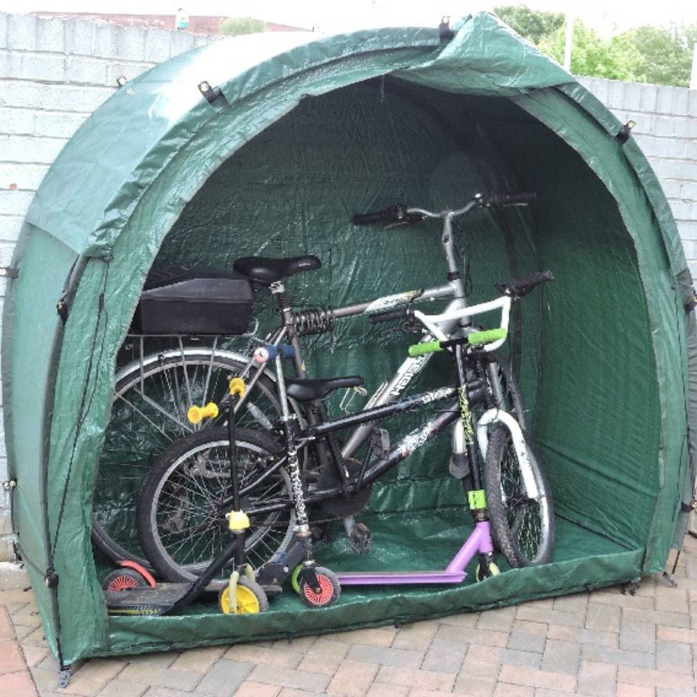 Open bike tent with kids' bikes and a scooter inside